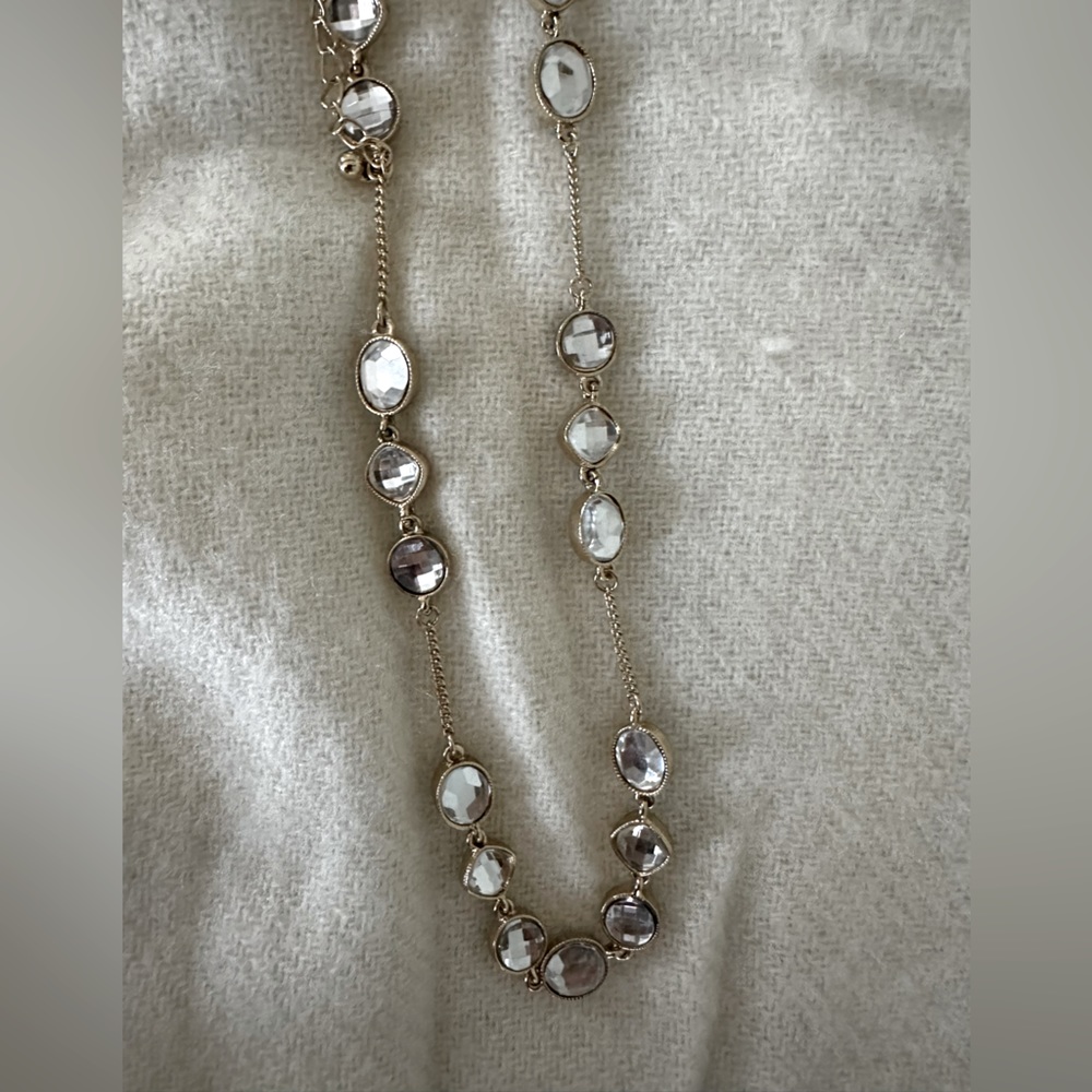 Long crystal necklace on gold-tone chain
